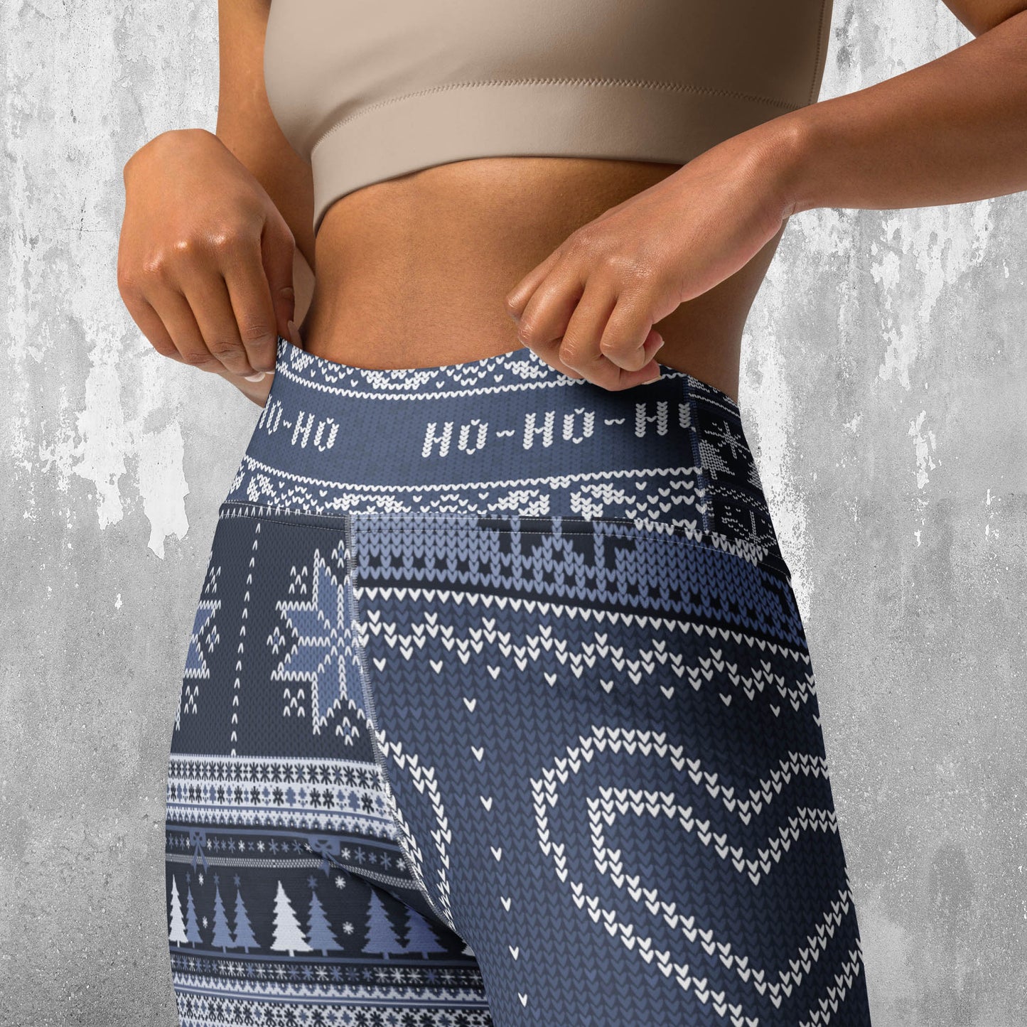 Navy blue patterned leggings with white accents worn by a person against a gray background